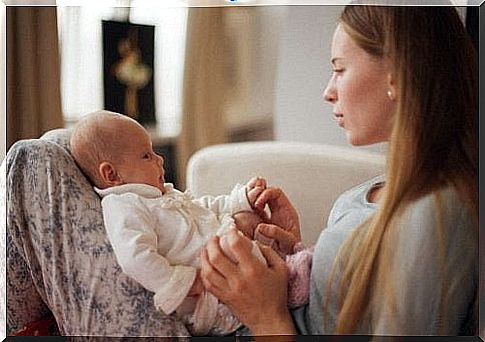 Mother looks at baby and talks to him.