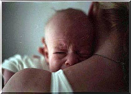 crying baby with his mother