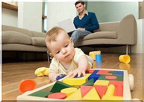 Baby plays with building blocks to stimulate the senses.