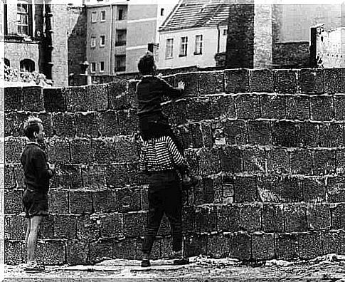 good father with children in front of wall