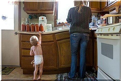 Mother and child are standing in the kitchen.