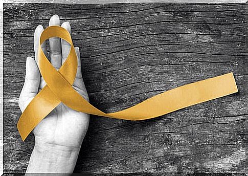 Golden ribbon shapes cancer symbol - symbol of the superheroes' fight against cancer