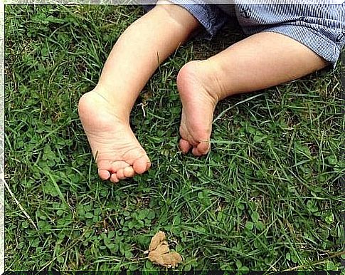 Walking barefoot on the grass.