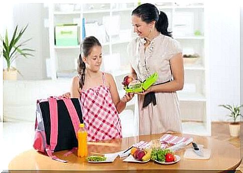 Morning routine - mother and daughter pack the school bag together