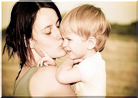 Mother doesn't scream, kisses child on the arm on the cheek